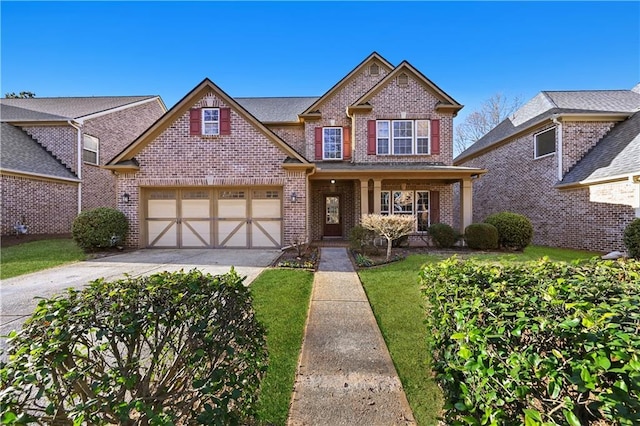 120 Daniel Creek Ln, Sugar Hill, GA 30518 - view of front of house featuring brick siding, driveway, a front yard, an attached garage, and covered porch