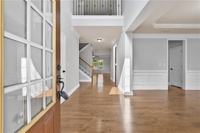 120 Daniel Creek Ln, Sugar Hill, GA 30518 - entrance foyer featuring crown molding, stairway, wood finished floors, and wainscoting