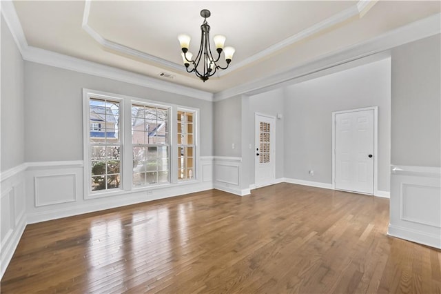 120 Daniel Creek Ln, Sugar Hill, GA 30518 - unfurnished dining area featuring a chandelier, wainscoting, wood finished floors, crown molding, and a decorative wall