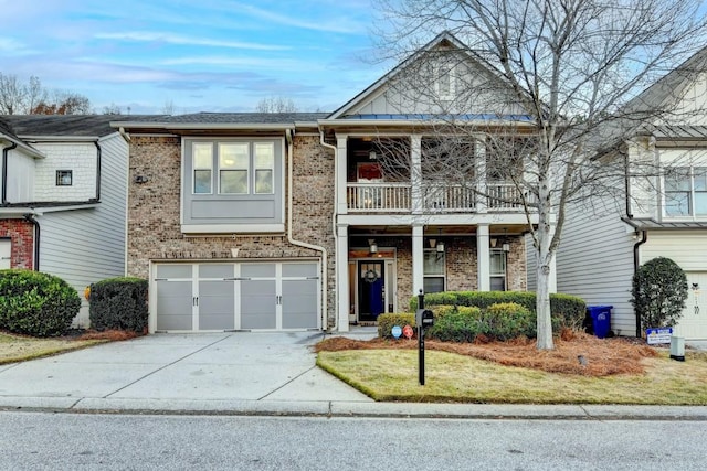 view of front of property featuring a balcony, a garage, and a front lawn