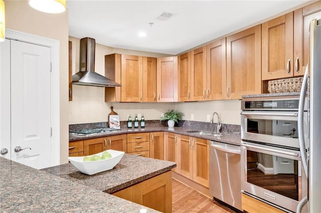 2881 Peachtree Rd NE Unit 1202, Atlanta, GA 30305 - kitchen featuring wall chimney exhaust hood, stainless steel appliances, a sink, light wood-style flooring, and dark stone counters