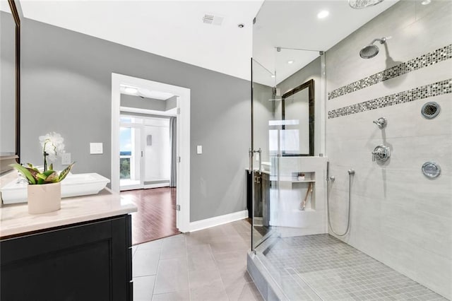 2881 Peachtree Rd NE Unit 1202, Atlanta, GA 30305 - full bath with vanity, a tile shower, tile patterned flooring, baseboards, and recessed lighting