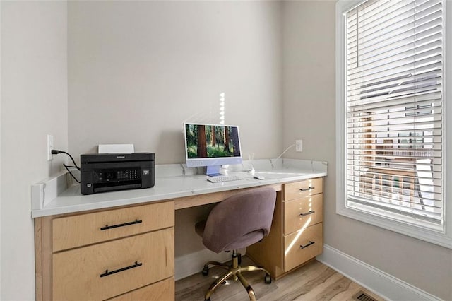 office space with light wood-type flooring