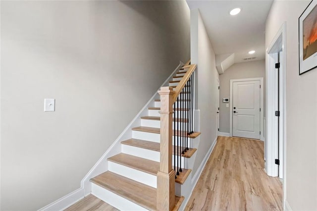 stairway featuring hardwood / wood-style floors