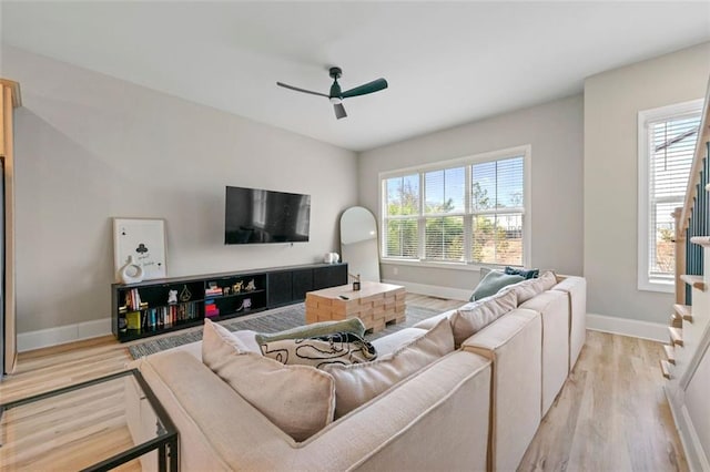 living room with ceiling fan and light hardwood / wood-style floors