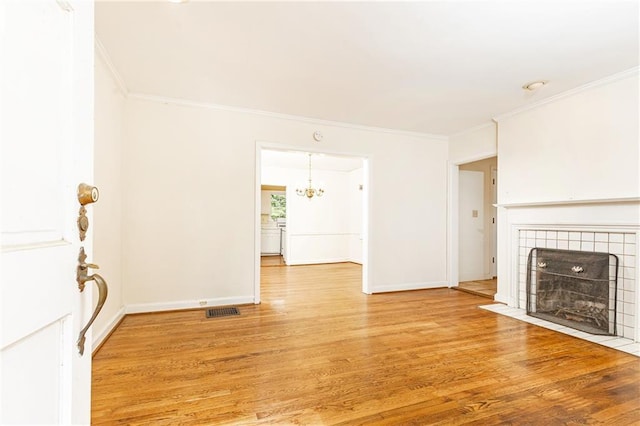 70 Mount Paran Rd NE, Atlanta, GA 30342 - unfurnished living room with a fireplace, crown molding, light wood finished floors, a chandelier, and baseboards