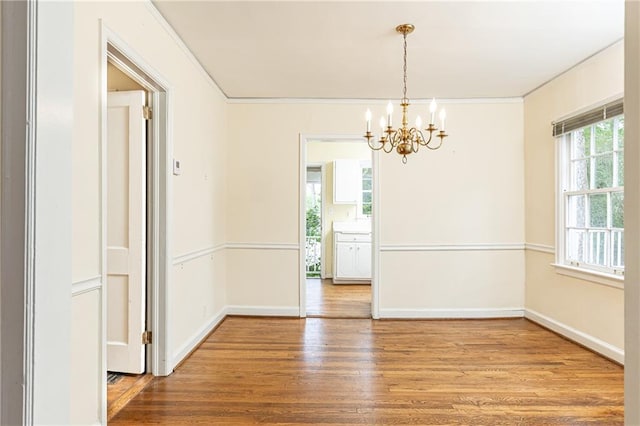 70 Mount Paran Rd NE, Atlanta, GA 30342 - unfurnished dining area featuring a chandelier, wood finished floors, ornamental molding, and baseboards