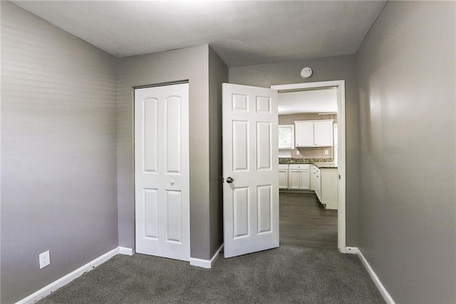 interior space with dark colored carpet