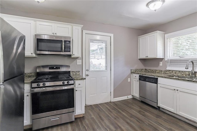 kitchen featuring stainless steel appliances, dark hardwood / wood-style floors, sink, and white cabinetry