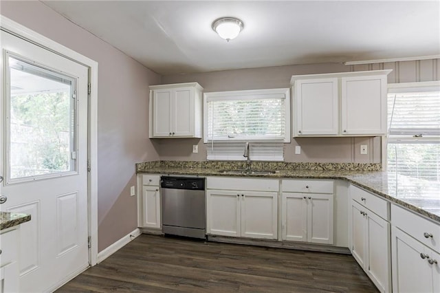 kitchen with white cabinetry, sink, stainless steel dishwasher, and a healthy amount of sunlight