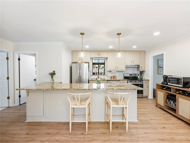 2466 Thrasher Rd, Buford, GA 30519 - kitchen featuring stainless steel appliances, light wood-style flooring, ornamental molding, under cabinet range hood, and light stone counters
