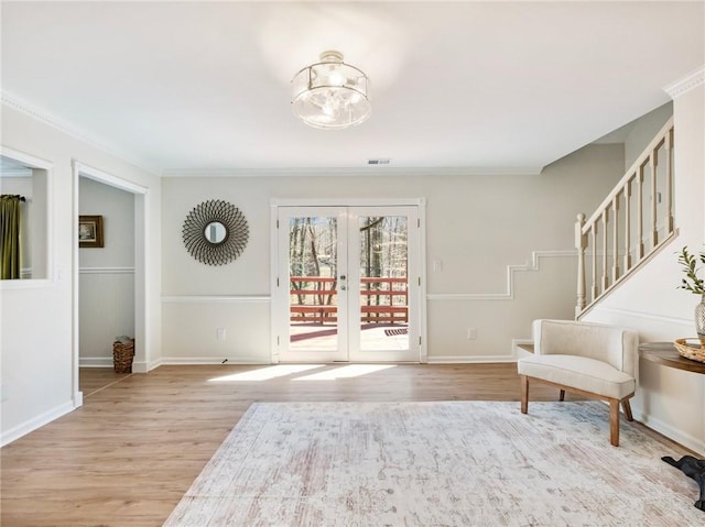 2466 Thrasher Rd, Buford, GA 30519 - sitting room featuring light wood-type flooring, french doors, ornamental molding, a chandelier, and stairway