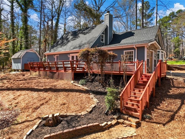 2466 Thrasher Rd, Buford, GA 30519 - rear view of house featuring a deck, a shingled roof, a chimney, and stairs