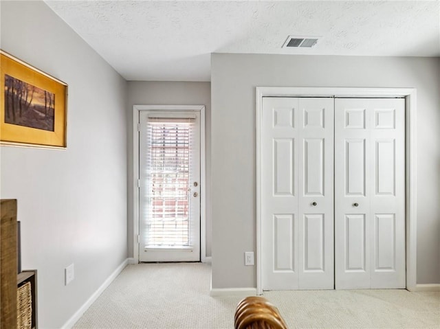 2466 Thrasher Rd, Buford, GA 30519 - carpeted bedroom featuring baseboards, a closet, and a textured ceiling