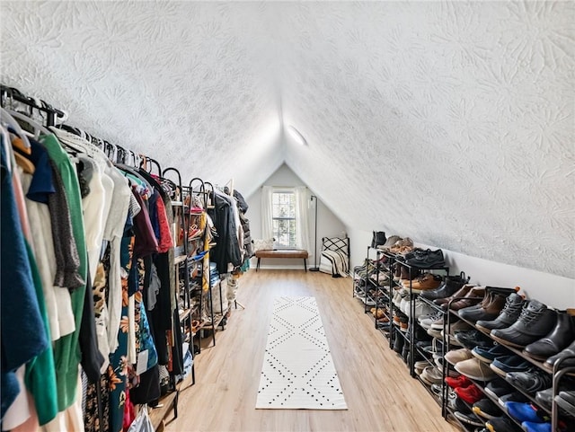 2466 Thrasher Rd, Buford, GA 30519 - walk in closet with lofted ceiling and wood finished floors