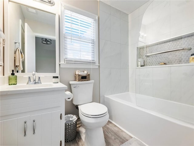 2466 Thrasher Rd, Buford, GA 30519 - full bathroom featuring toilet, vanity, wood finished floors, and bathing tub / shower combination