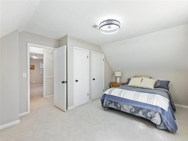 2466 Thrasher Rd, Buford, GA 30519 - bedroom with light colored carpet, vaulted ceiling, and baseboards