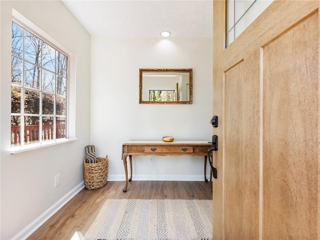 2466 Thrasher Rd, Buford, GA 30519 - entrance foyer with wood finished floors, healthy amount of natural light, and baseboards