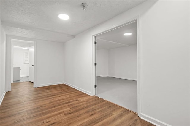 110 Glen Eagle Way, Mcdonough, GA 30253 - spare room with wood finished floors, a textured ceiling, and baseboards
