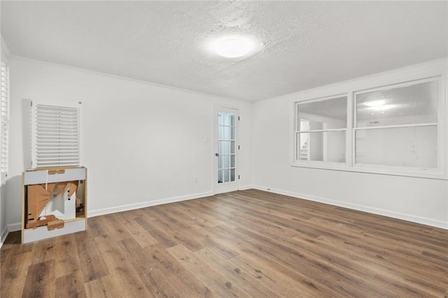 110 Glen Eagle Way, Mcdonough, GA 30253 - unfurnished room with a textured ceiling, wood finished floors, and baseboards