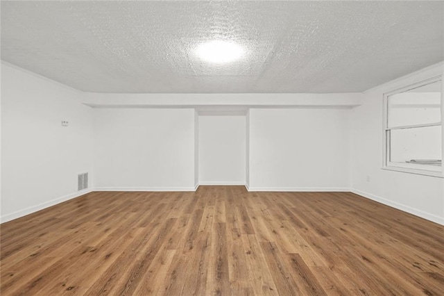110 Glen Eagle Way, Mcdonough, GA 30253 - spare room with wood finished floors, a textured ceiling, and baseboards