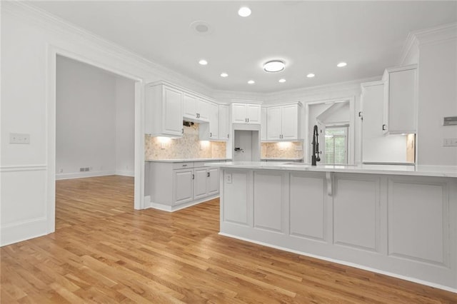 110 Glen Eagle Way, Mcdonough, GA 30253 - kitchen with a peninsula, light countertops, crown molding, white cabinets, and tasteful backsplash