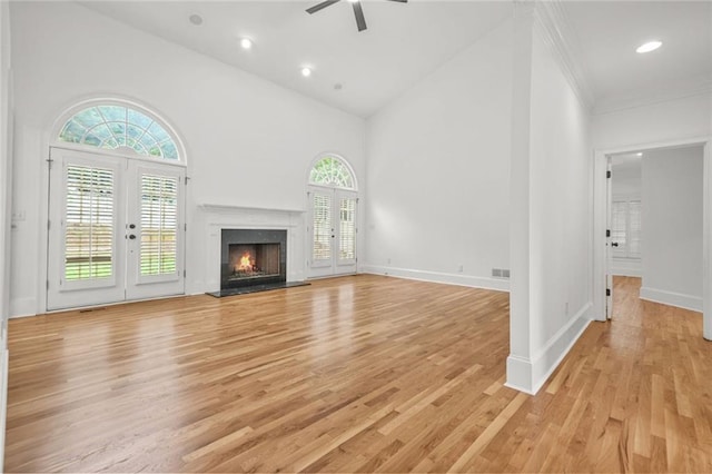 110 Glen Eagle Way, Mcdonough, GA 30253 - unfurnished living room with a ceiling fan, light wood-type flooring, high vaulted ceiling, a premium fireplace, and french doors