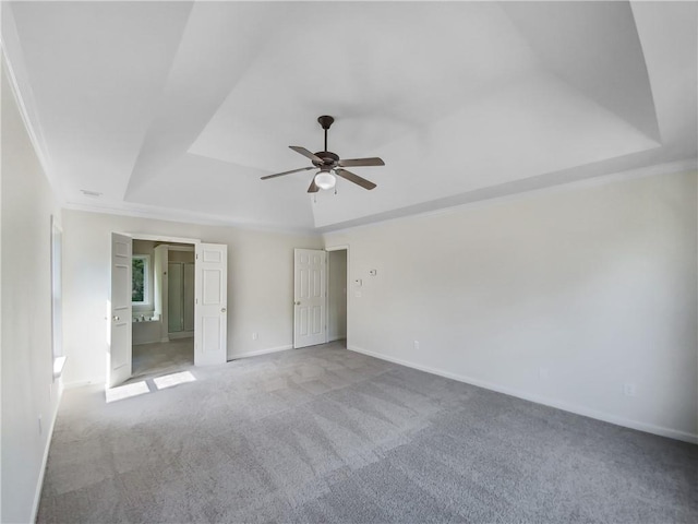 interior space featuring ceiling fan, crown molding, and a tray ceiling