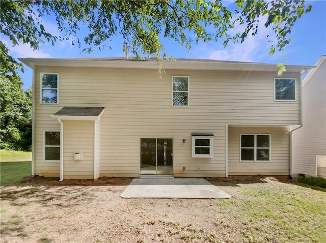 back of house featuring a yard and a patio