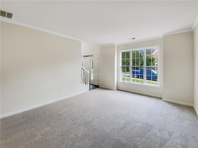 carpeted spare room with crown molding