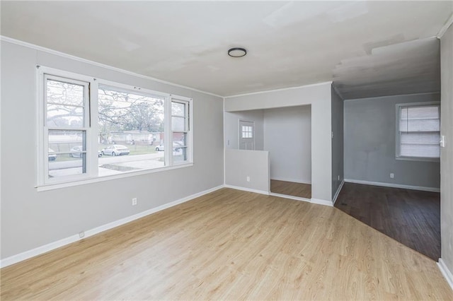 spare room featuring crown molding and hardwood / wood-style floors