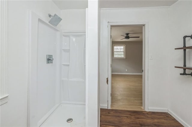 bathroom featuring hardwood / wood-style flooring, ceiling fan, and walk in shower