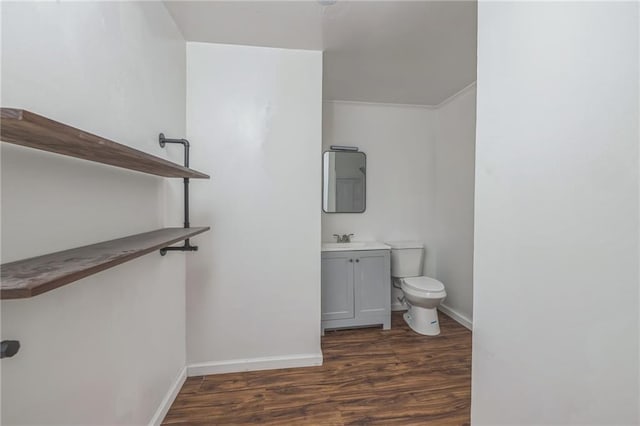 bathroom featuring vanity, wood-type flooring, and toilet