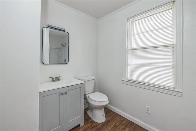 bathroom featuring vanity, hardwood / wood-style flooring, toilet, and crown molding