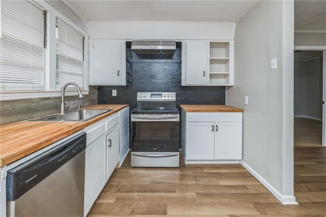 kitchen featuring white cabinets, appliances with stainless steel finishes, and butcher block countertops