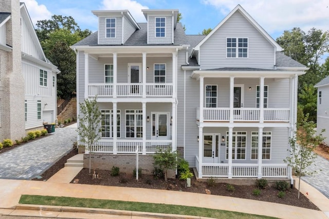 view of front of home featuring a porch, roof with shingles, and a balcony