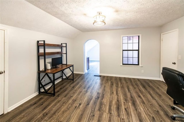 5479 Dorsett Shoals Rd, Douglasville, GA 30135 - unfurnished office with a textured ceiling, arched walkways, dark wood-style floors, vaulted ceiling, and baseboards