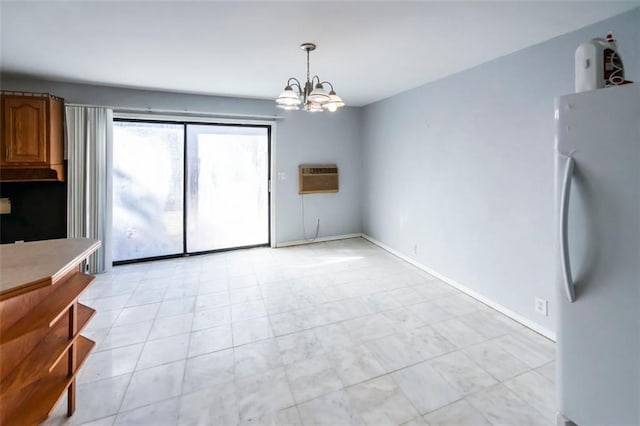 5479 Dorsett Shoals Rd, Douglasville, GA 30135 - unfurnished dining area featuring a chandelier, a wall mounted air conditioner, and baseboards