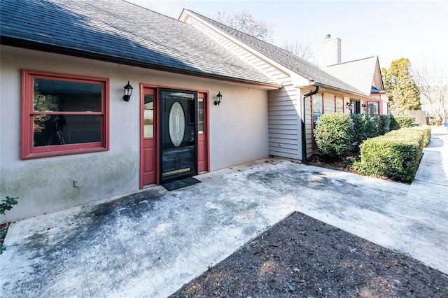 5479 Dorsett Shoals Rd, Douglasville, GA 30135 - entrance to property with roof with shingles, a chimney, and stucco siding