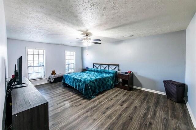5479 Dorsett Shoals Rd, Douglasville, GA 30135 - bedroom featuring dark wood-type flooring, baseboards, a textured ceiling, and ceiling fan