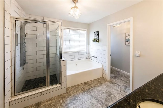 5479 Dorsett Shoals Rd, Douglasville, GA 30135 - full bathroom featuring a garden tub, a shower stall, baseboards, and a chandelier