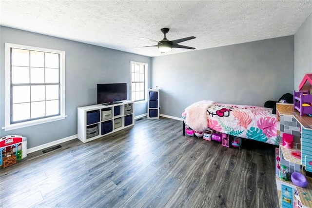 5479 Dorsett Shoals Rd, Douglasville, GA 30135 - bedroom with wood finished floors, baseboards, a textured ceiling, and ceiling fan