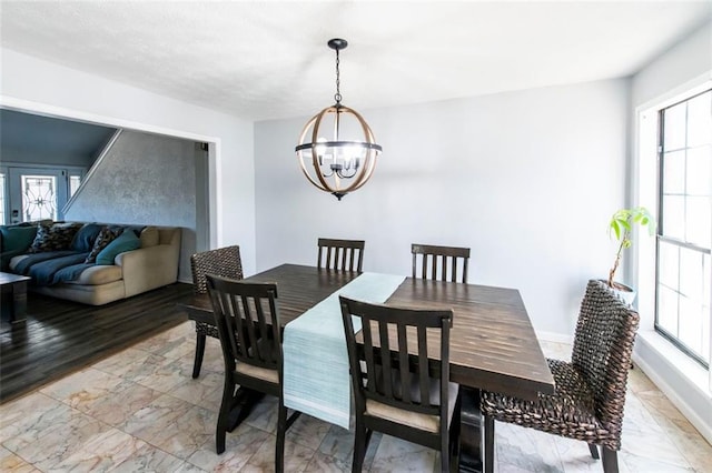 5479 Dorsett Shoals Rd, Douglasville, GA 30135 - dining space featuring a chandelier and light marble finish floors