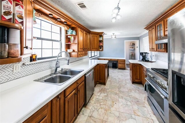 5479 Dorsett Shoals Rd, Douglasville, GA 30135 - kitchen with stainless steel appliances, open shelves, a sink, light countertops, and a textured ceiling