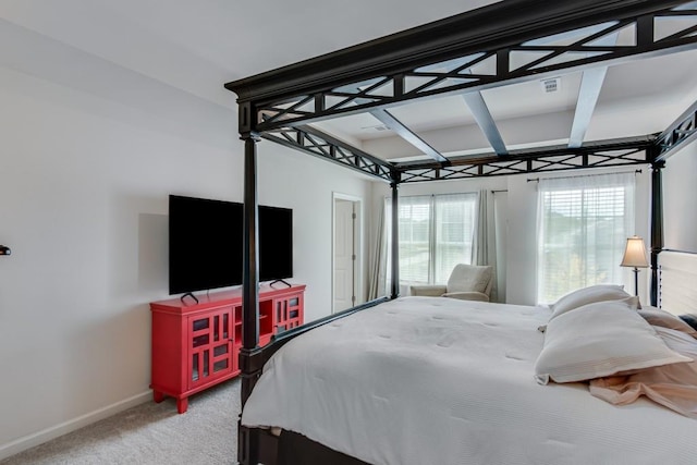 bedroom featuring carpet flooring and beamed ceiling