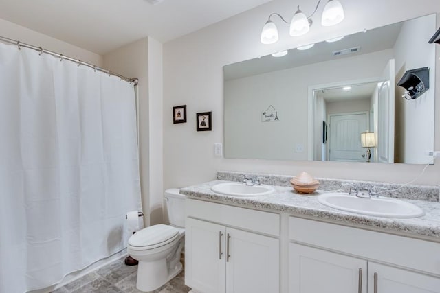 full bathroom featuring vanity, toilet, and shower / tub combo with curtain