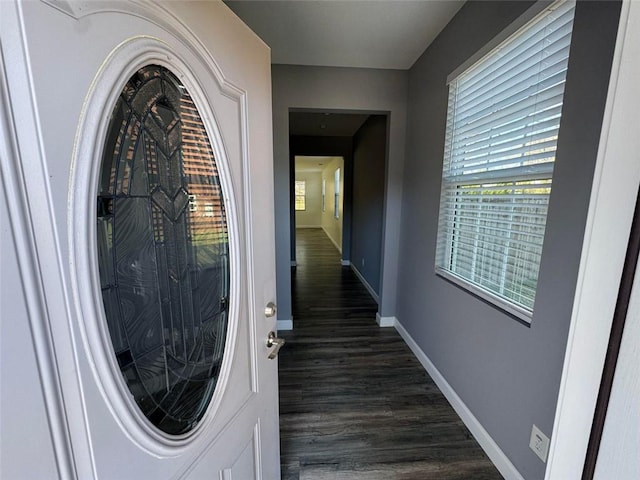 interior space with dark wood-style flooring and baseboards