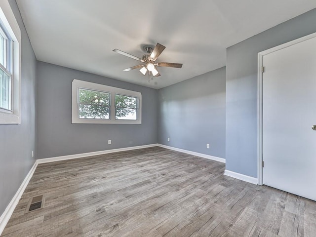 spare room with ceiling fan and light hardwood / wood-style flooring