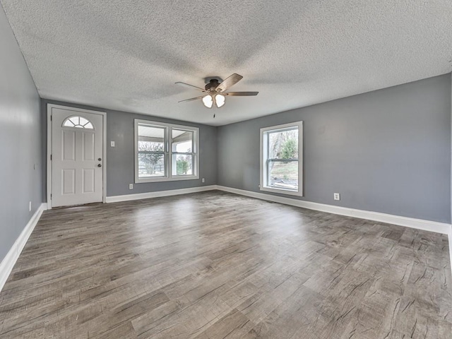 foyer entrance featuring hardwood / wood-style flooring, a textured ceiling, and ceiling fan