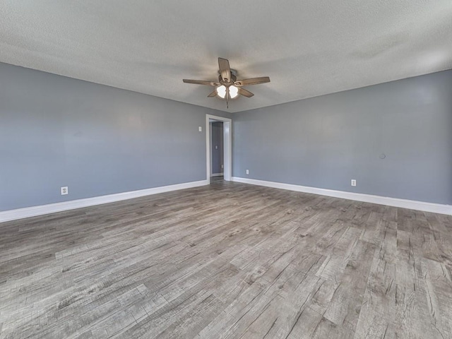 unfurnished room featuring a textured ceiling, ceiling fan, and light hardwood / wood-style flooring